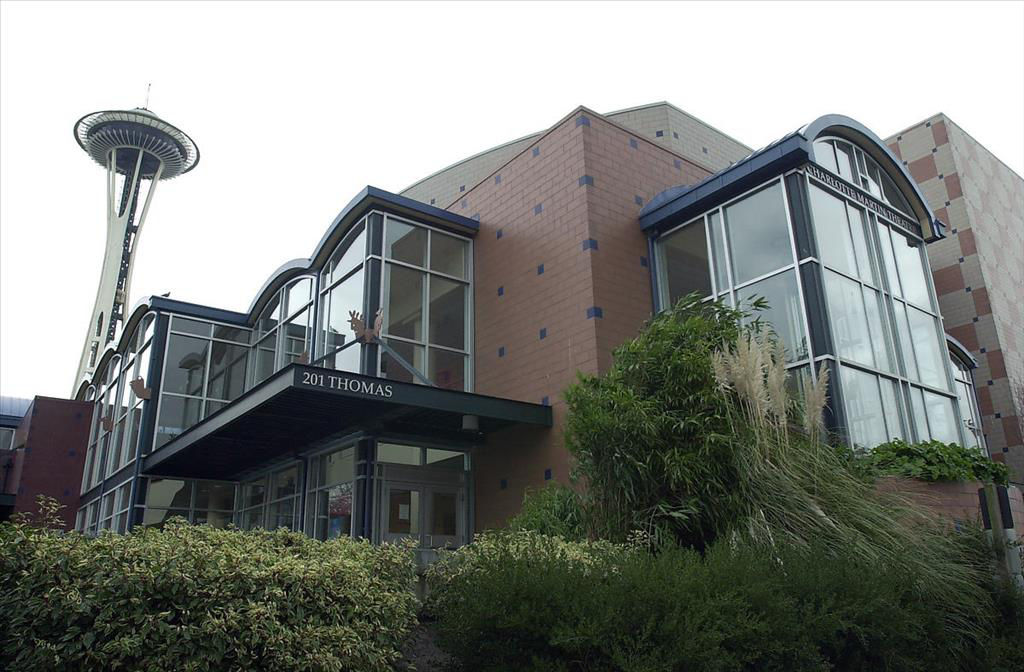 An exterior image of Seattle Children's Theatre with the Space Needle in the background.