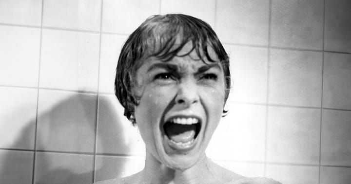 A still from the movie "Psycho" of Marion screaming in the shower. 