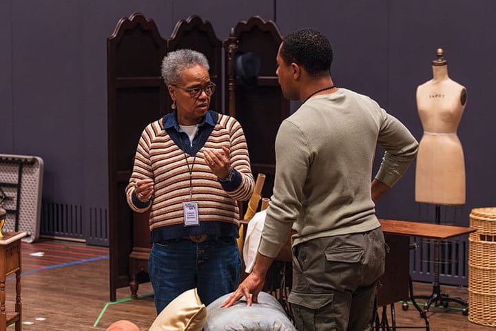 A director and actor work talk during a rehearsal of a play.